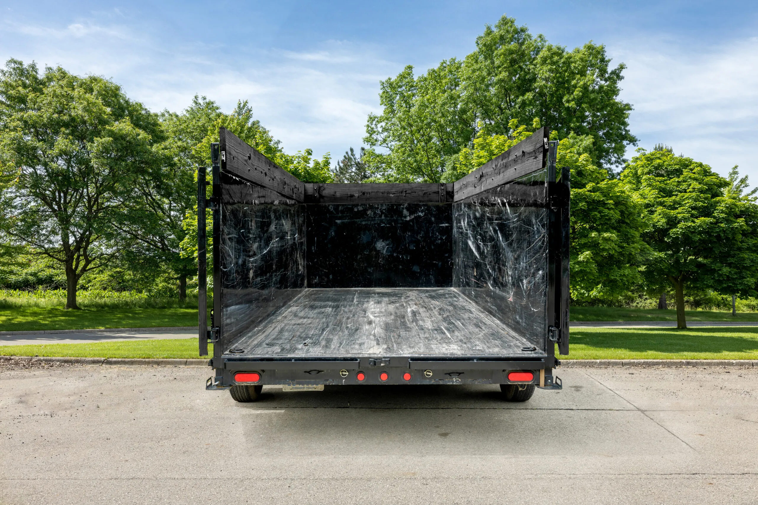 Open 20-yard dump trailer viewed from the rear with its doors open