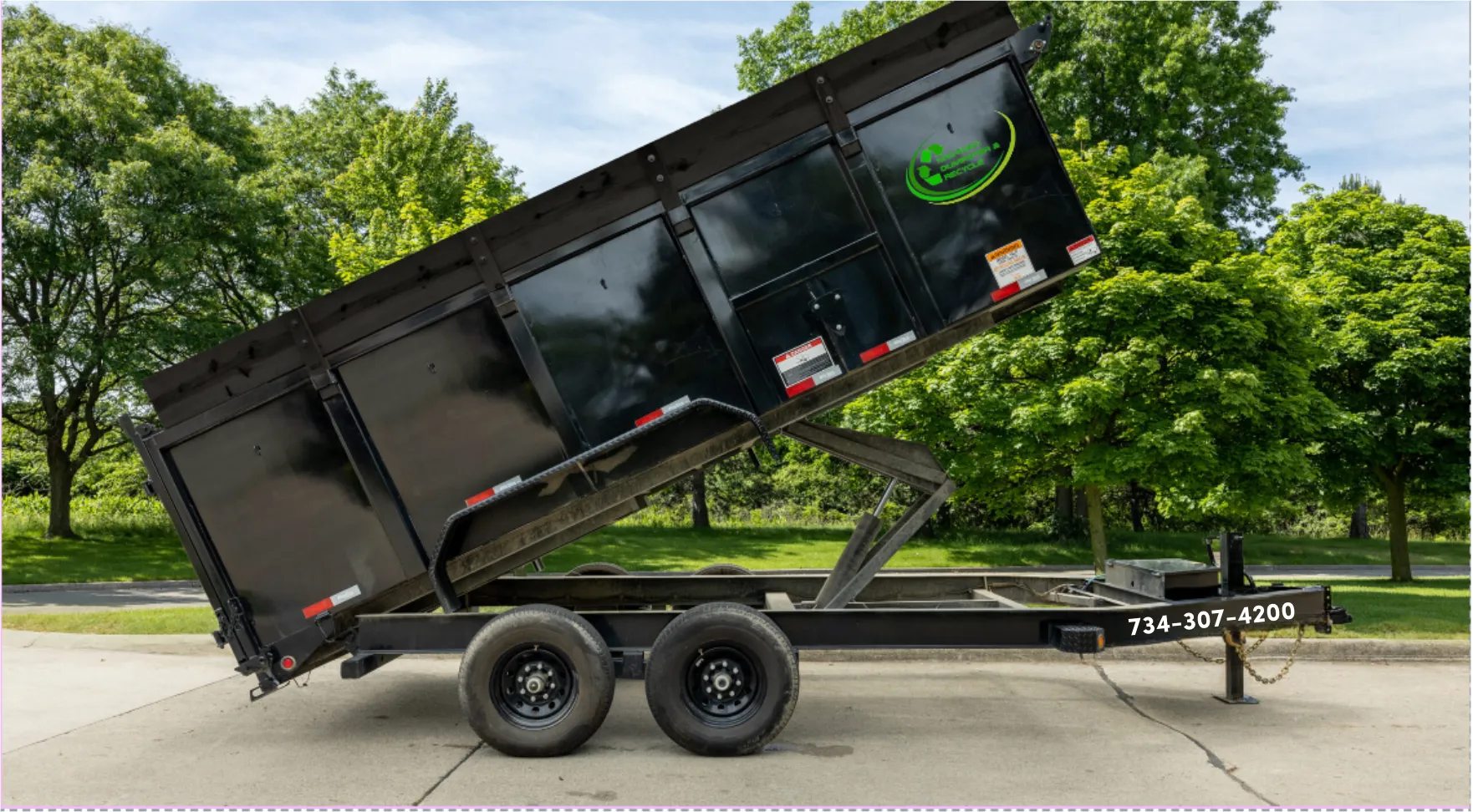 Dump trailer tilted up to unload debris